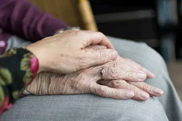 Therapist assisting with adaptive equipment